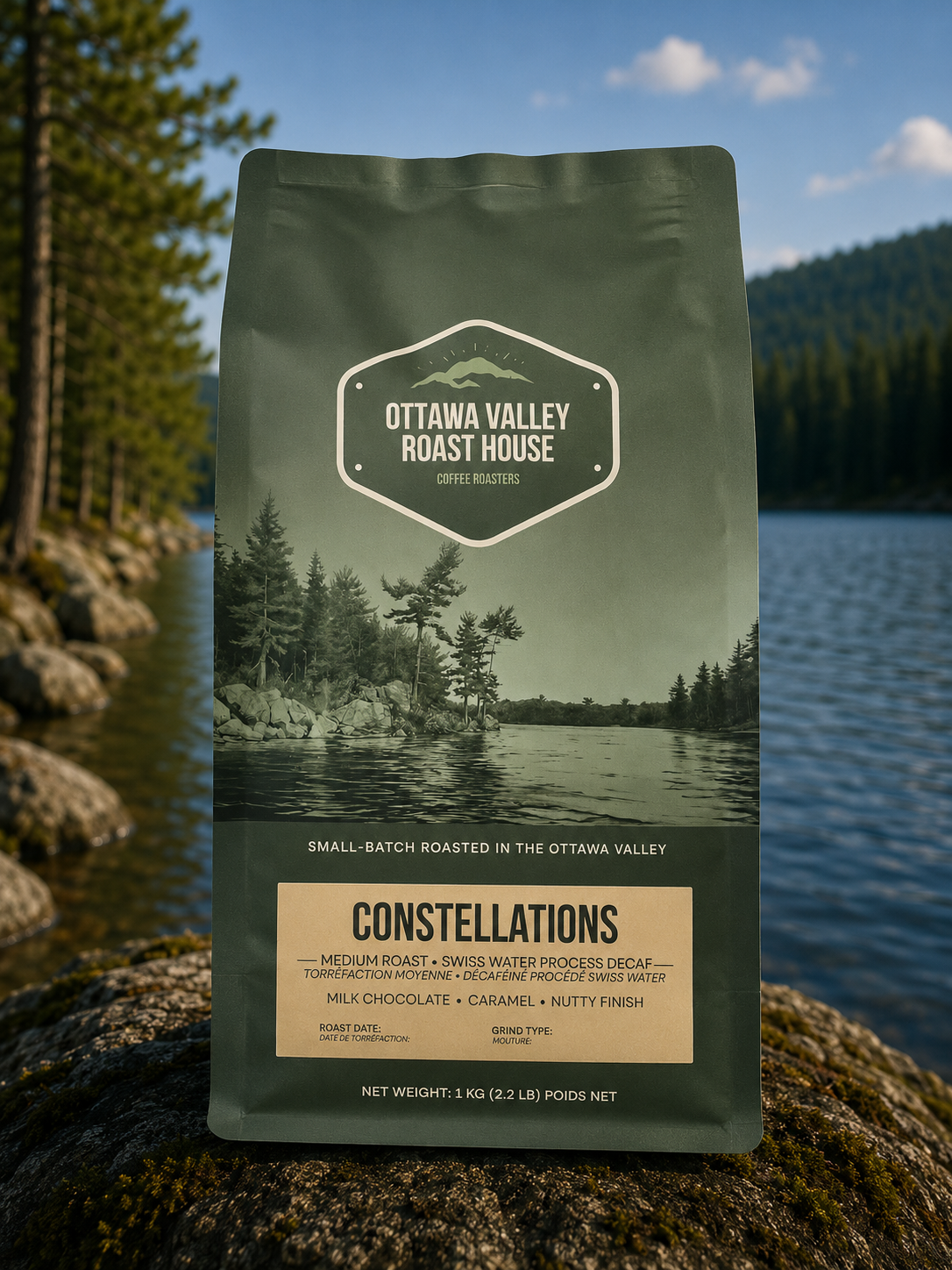 A bag of Ottawa Valley Roast House Constellations coffee stands on a mossy log with a scenic lake and forest background.