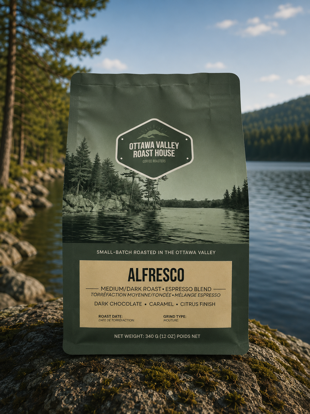 A bag of Ottawa Valley Roast House Alfresco espresso blend coffee stands upright on a mossy rock with a forest and lake background.
