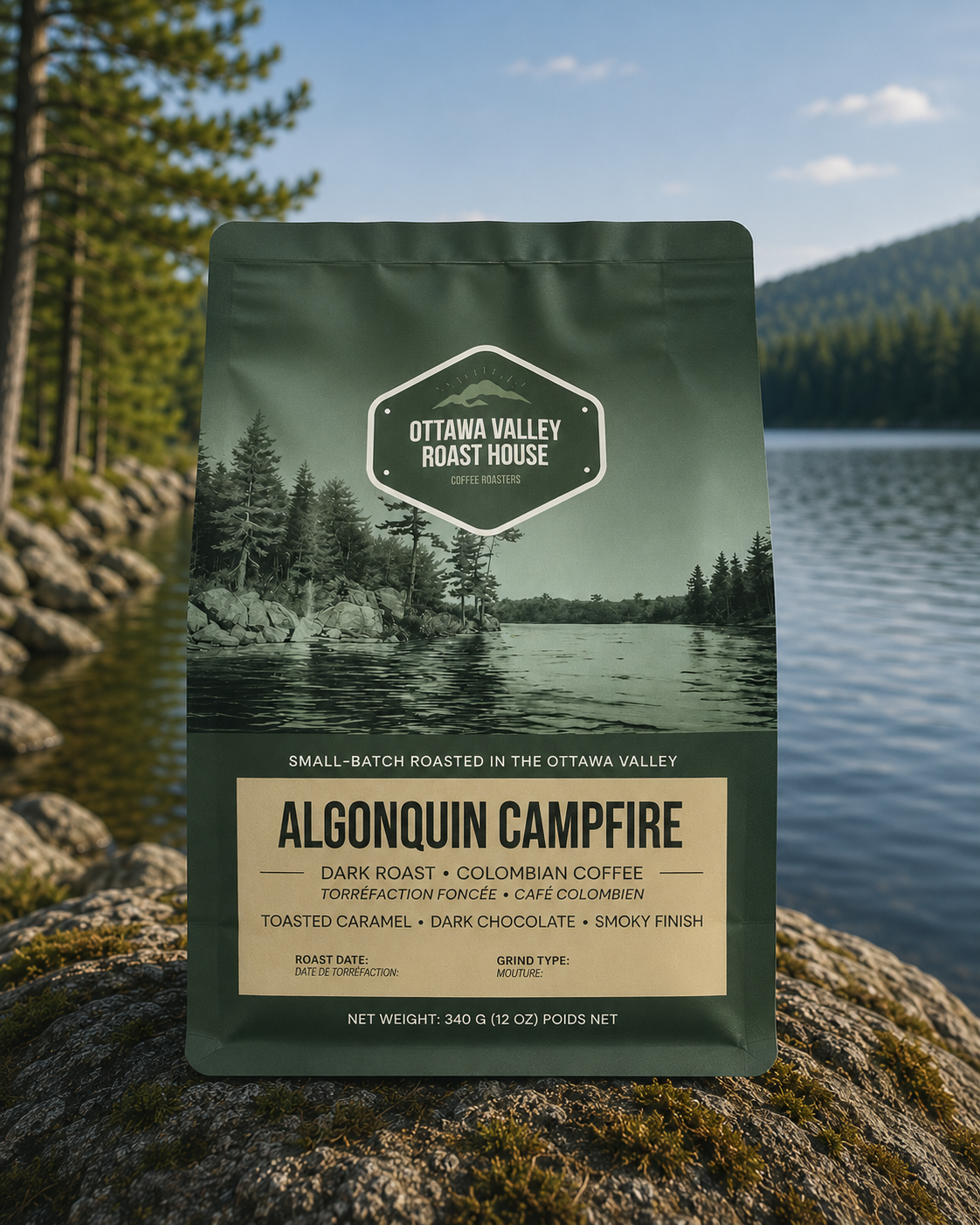 A stand-up coffee bag labeled Ottawa Valley Roast House Algonquin Campfire stands on a rock outdoors with a lake, trees, and mountains in the background.