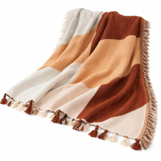 Color-blocked blanket with tassels on a white background