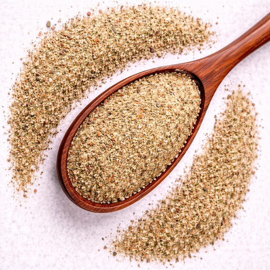 Wooden spoon filled with ground spice on a white background