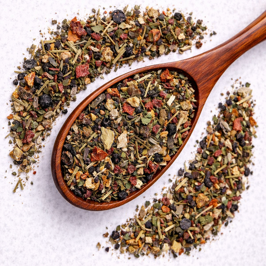 Wooden spoon filled with a mix of dried herbs and spices on a white background