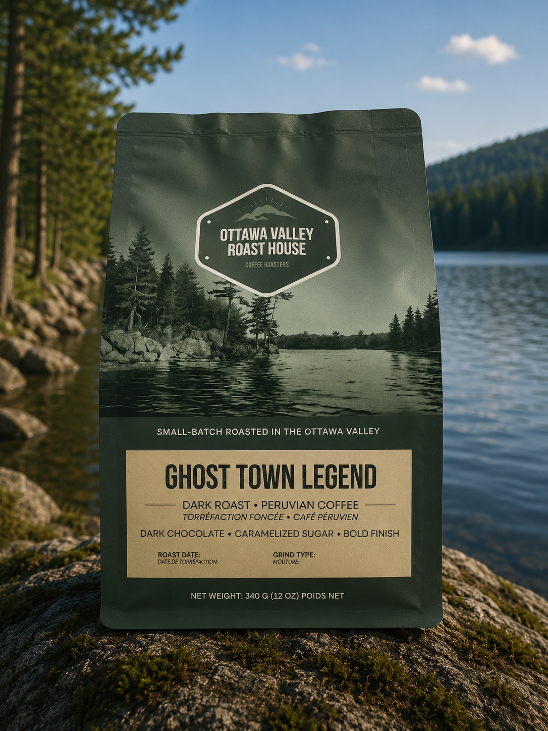 A bag of Ottawa Valley Roast House Ghost Town Legend dark roast coffee stands upright on a mossy log with a scenic lake and forest background.