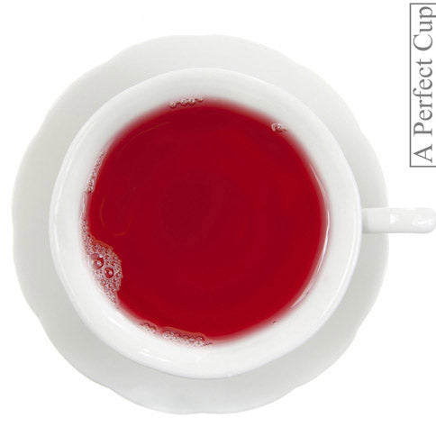 White teacup filled with red liquid on a white background, with 'A Perfect Cup' branding.