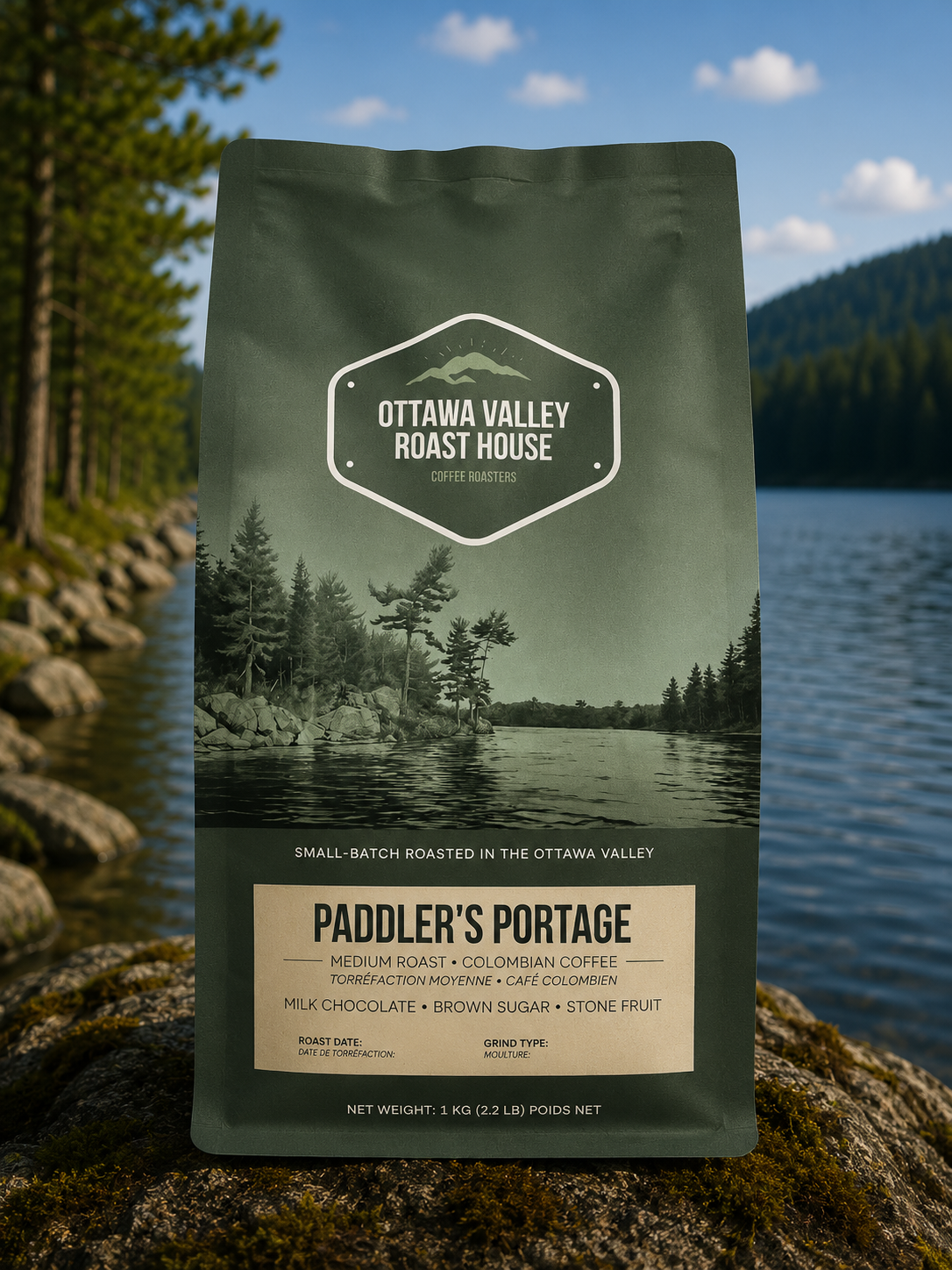 A stand-up coffee bag from Ottawa Valley Roast House labeled Paddler's Portage, photographed outdoors on a rock with a lake, forest, and mountains in the background.