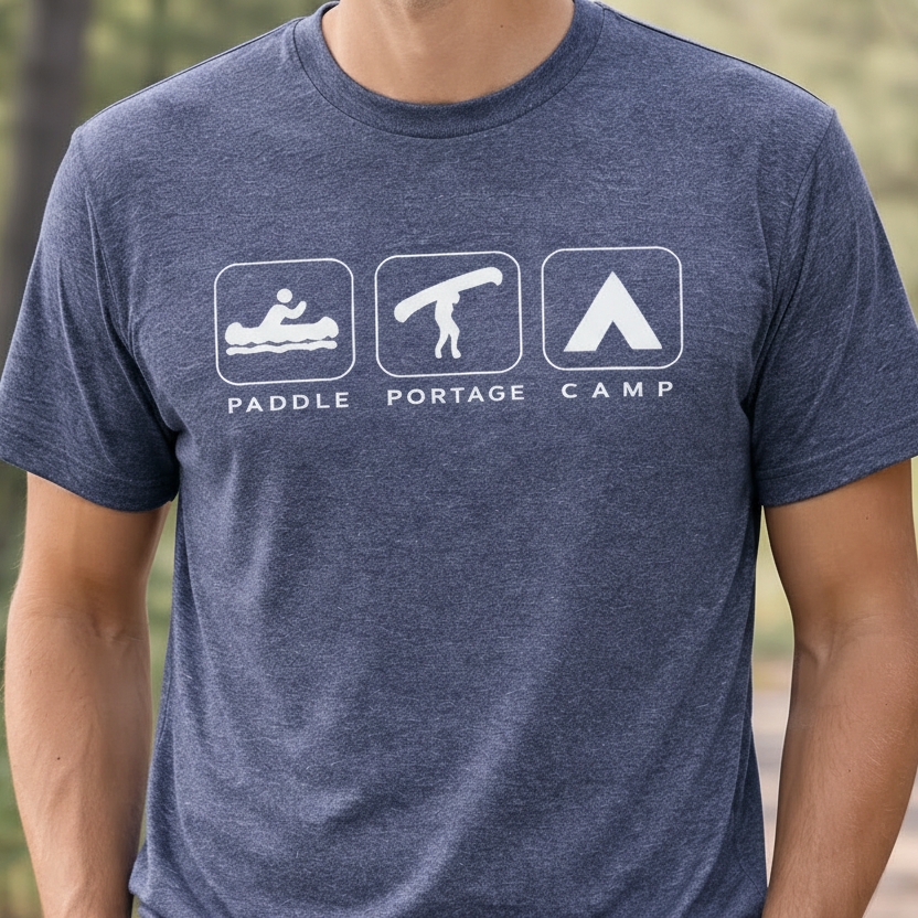Person wearing a blue t-shirt with outdoor-themed graphics and text.