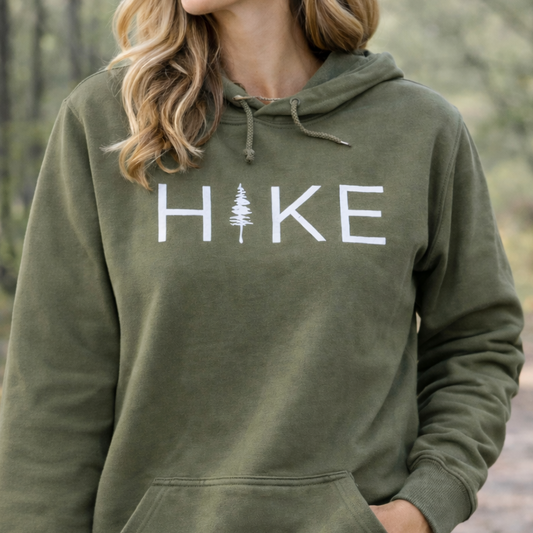 Person wearing a green hoodie with 'Hike' printed on it, standing outdoors.