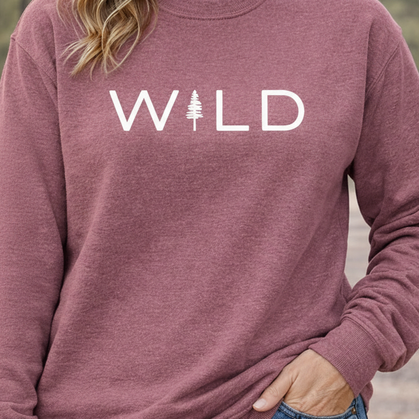 Maroon sweatshirt with 'WILD' printed on it, worn by a person.