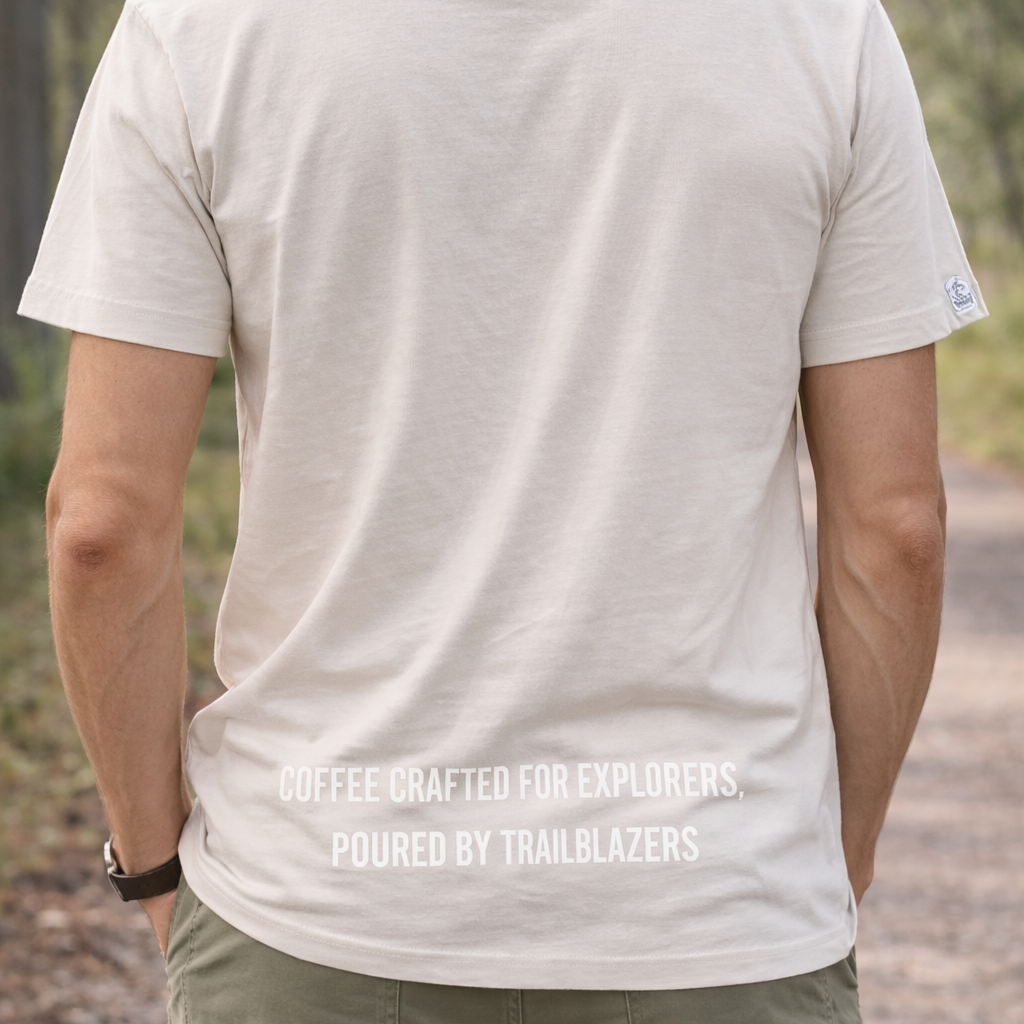 Person wearing a white t-shirt with text on the back, standing outdoors.