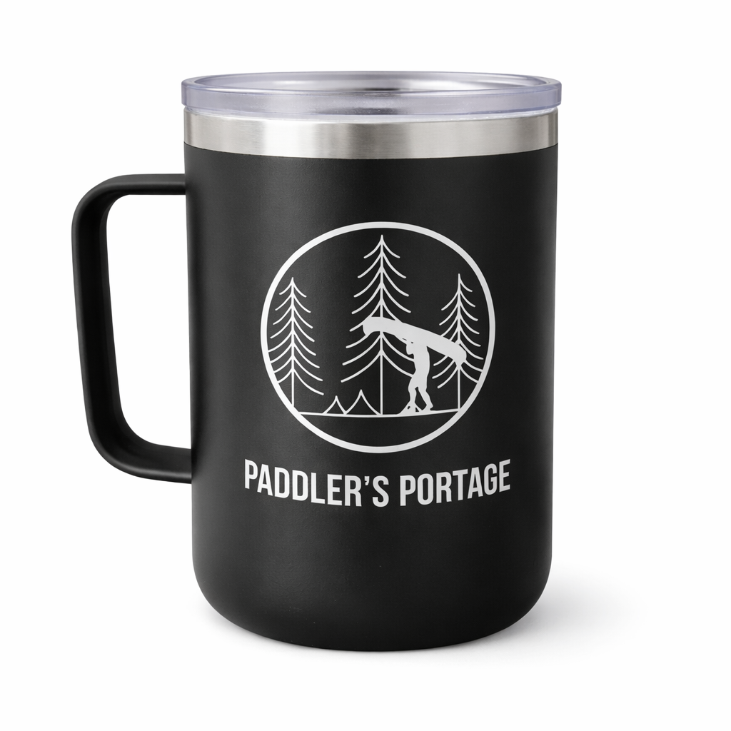 Black mug with 'Paddler's Portage' design featuring a canoe and trees on a white background