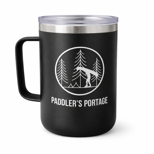 Black mug with 'Paddler's Portage' design featuring a canoe and trees on a white background